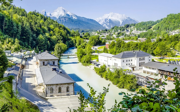 Aerial view of Berchtesgaden Salt Mine in Bavaria with surrounding mountains and river.