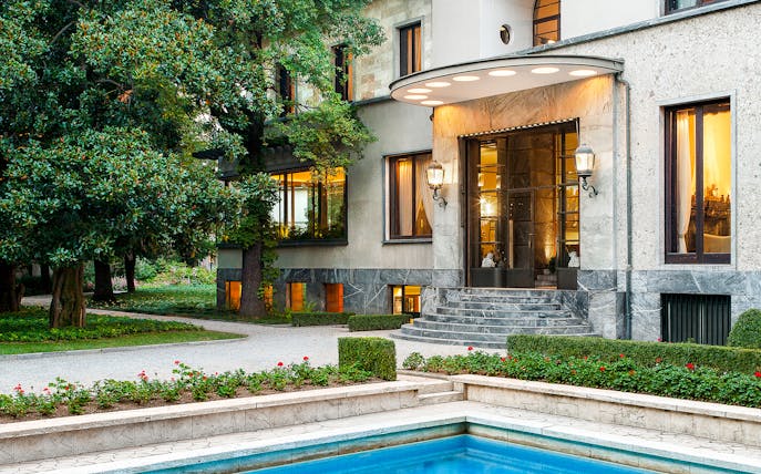 Villa Necchi Campiglio entrance with garden and pool in Milan, Italy.