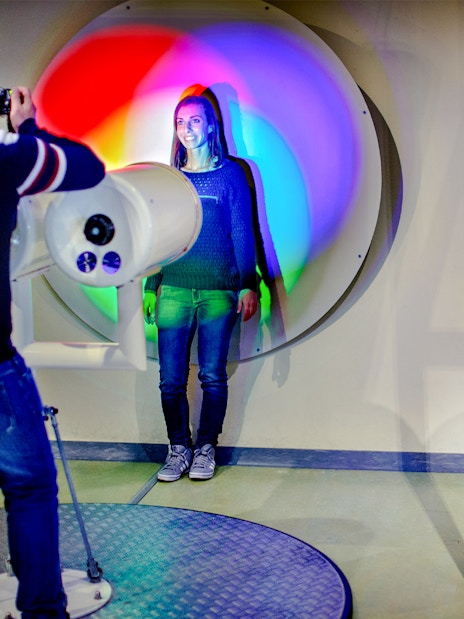 Visitors engaging with interactive light and pulley exhibits at NEMO Science Museum.