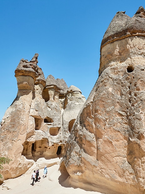 Rock formations in Pasabag Valley, Cappadocia with tourists exploring the area.