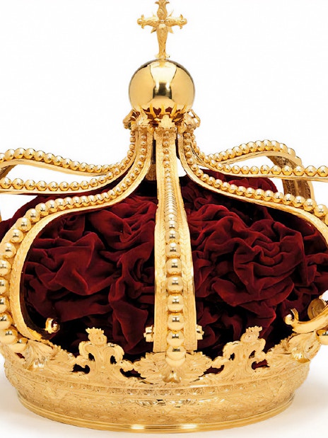 Golden crown with red velvet interior at Royal Treasure Museum.
