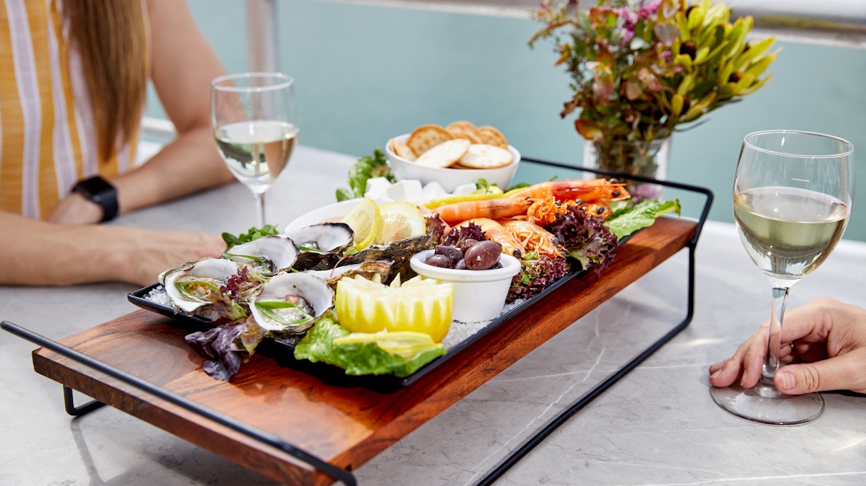 Seafood platter with oysters and prawns on Darwin Harbour lunch cruise table.