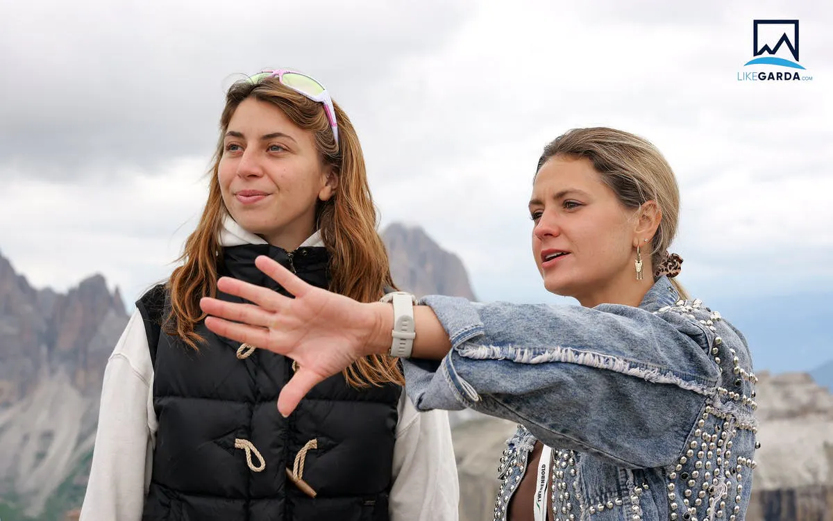 Tour guide explaining Dolomites view to visitor during Verona bus tour.