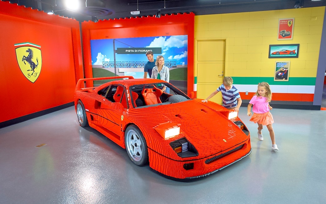 Children exploring a LEGO Ferrari at LEGOLAND® California's Build and Race attraction.