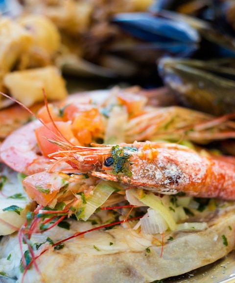 Maltese seafood platter with prawns, mussels, and fish.