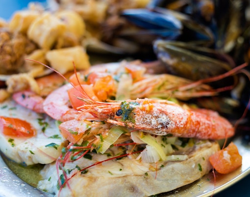 seafood platter with prawns, mussels, and fish.
