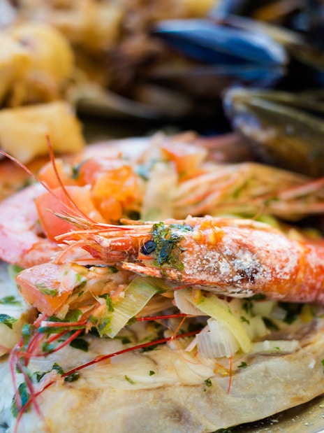 Maltese seafood platter with prawns, mussels, and fish.