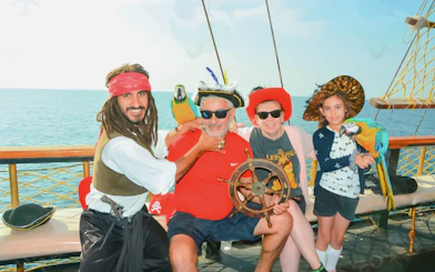 Guests on Pirate Ship Cruise with parrot in Antalya, Turkey.