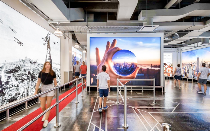 Visitors inside the Empire State Building exhibit in NYC.