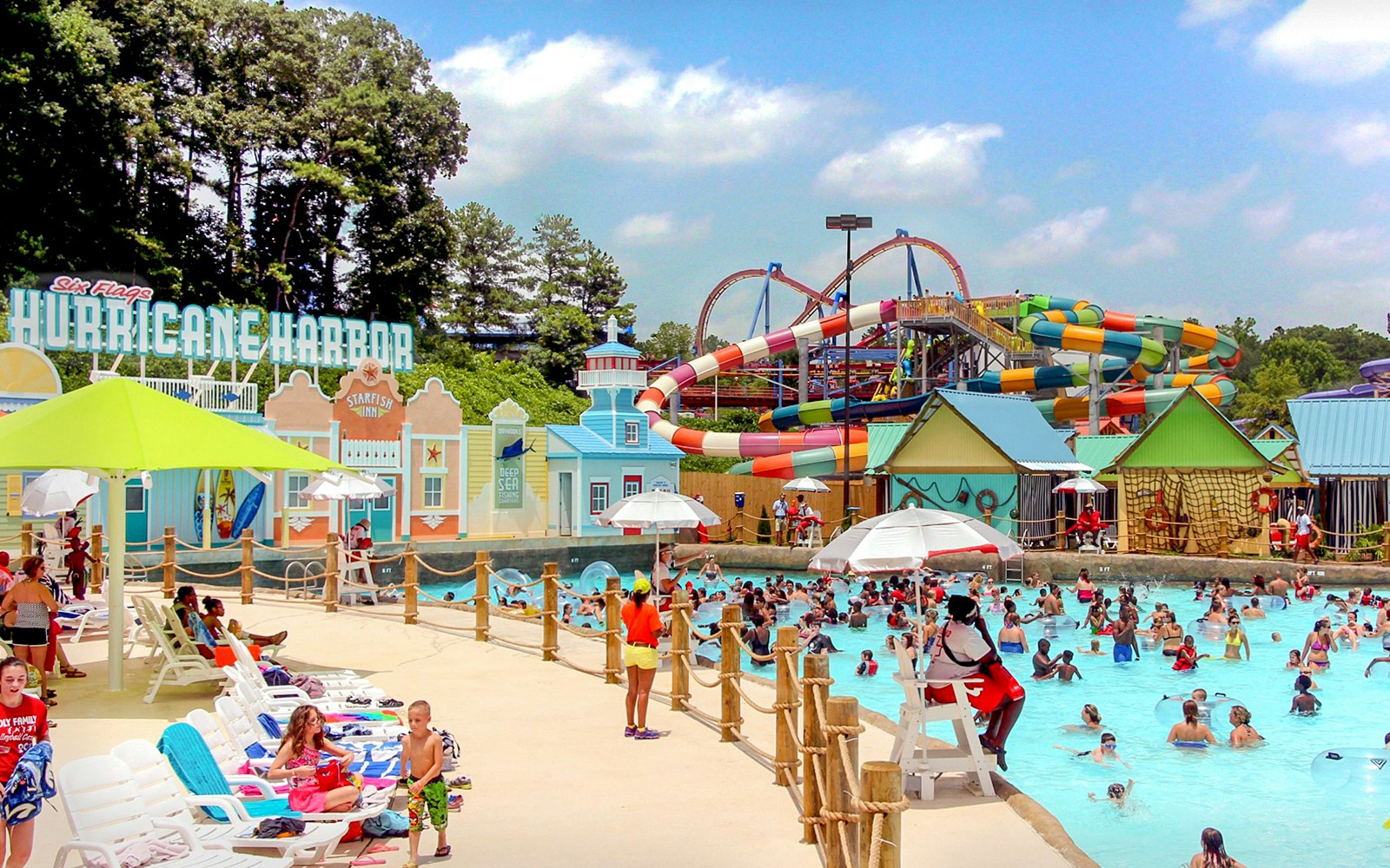 Hurricane Harbor water park at Six Flags Over Georgia with colorful slides and a crowded pool.