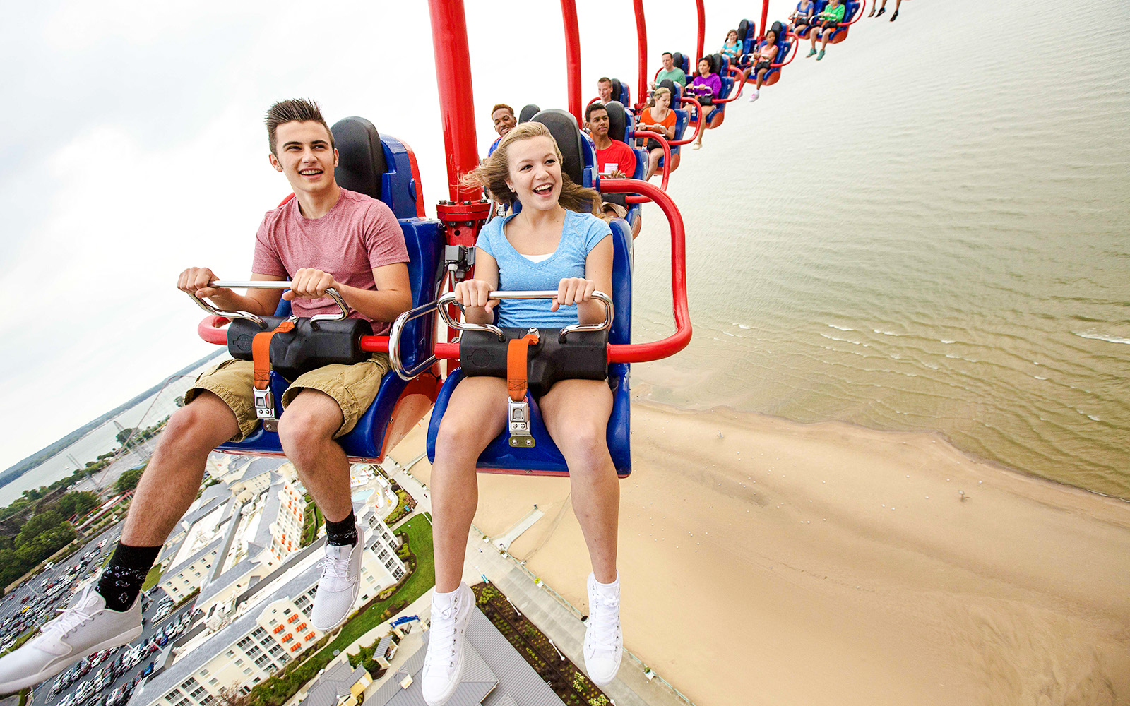 Riders enjoying WindSeeker ride at Cedar Point with a view of the beach below.