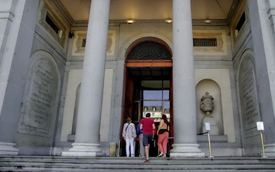 Visitors entering the Prado Museum in Madrid for a guided tour.