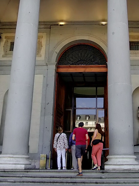 Visitors entering the Prado Museum in Madrid for a guided tour.