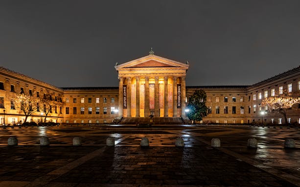 Philadelphia Museum of Art illuminated at night during a city tour.
