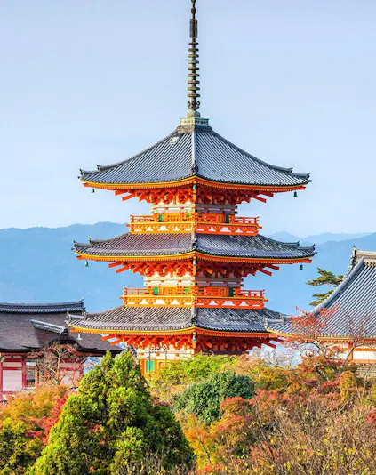 Kiyomizudera Temple pagoda surrounded by autumn foliage in Kyoto, Japan.