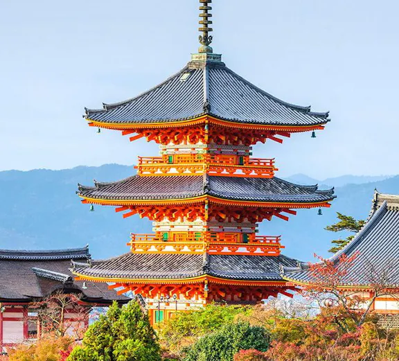 Kiyomizudera Temple pagoda surrounded by autumn foliage in Kyoto, Japan.