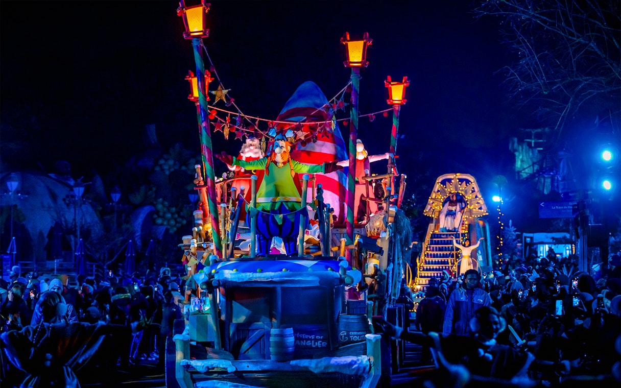Parade float with Astérix character at night in Astérix Park, France.