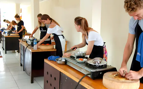 Participants cooking at Ketut’s Bali Cooking Class in Ubud.
