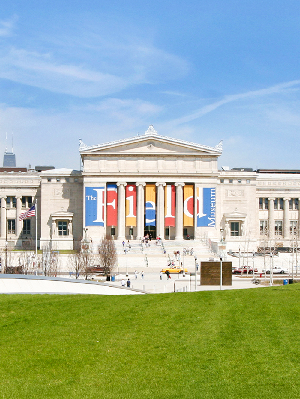 Field Museum of Natural History entrance in Chicago with visitors on steps.