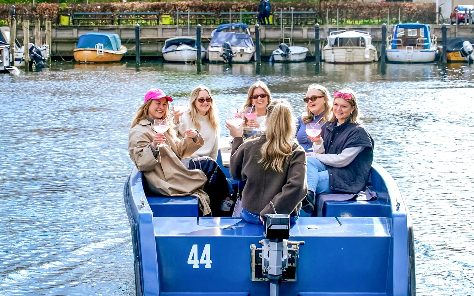Copenhagen harbor boat tour with guests passing colorful waterfront buildings.