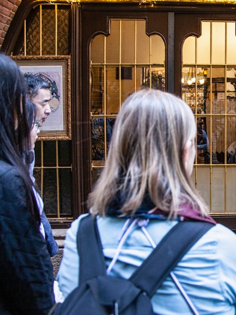 Guide explaining to visitors outside 4 Cats restaurant in Barcelona.