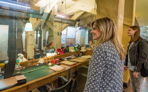 Guests observing the historic operations room inside the Churchill War Rooms, London.