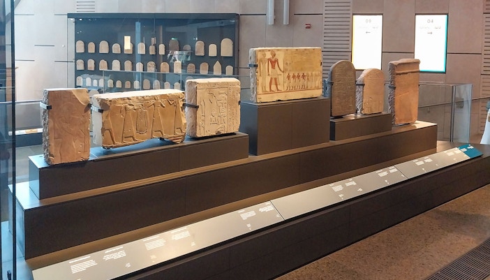 Visitors exploring artifacts at the Grand Egyptian Museum in Cairo with skip-the-line tickets.