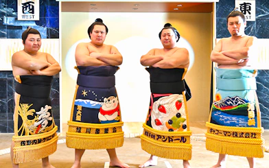 Sumo wrestlers posing at Asakusa Sumo Club, Tokyo.
