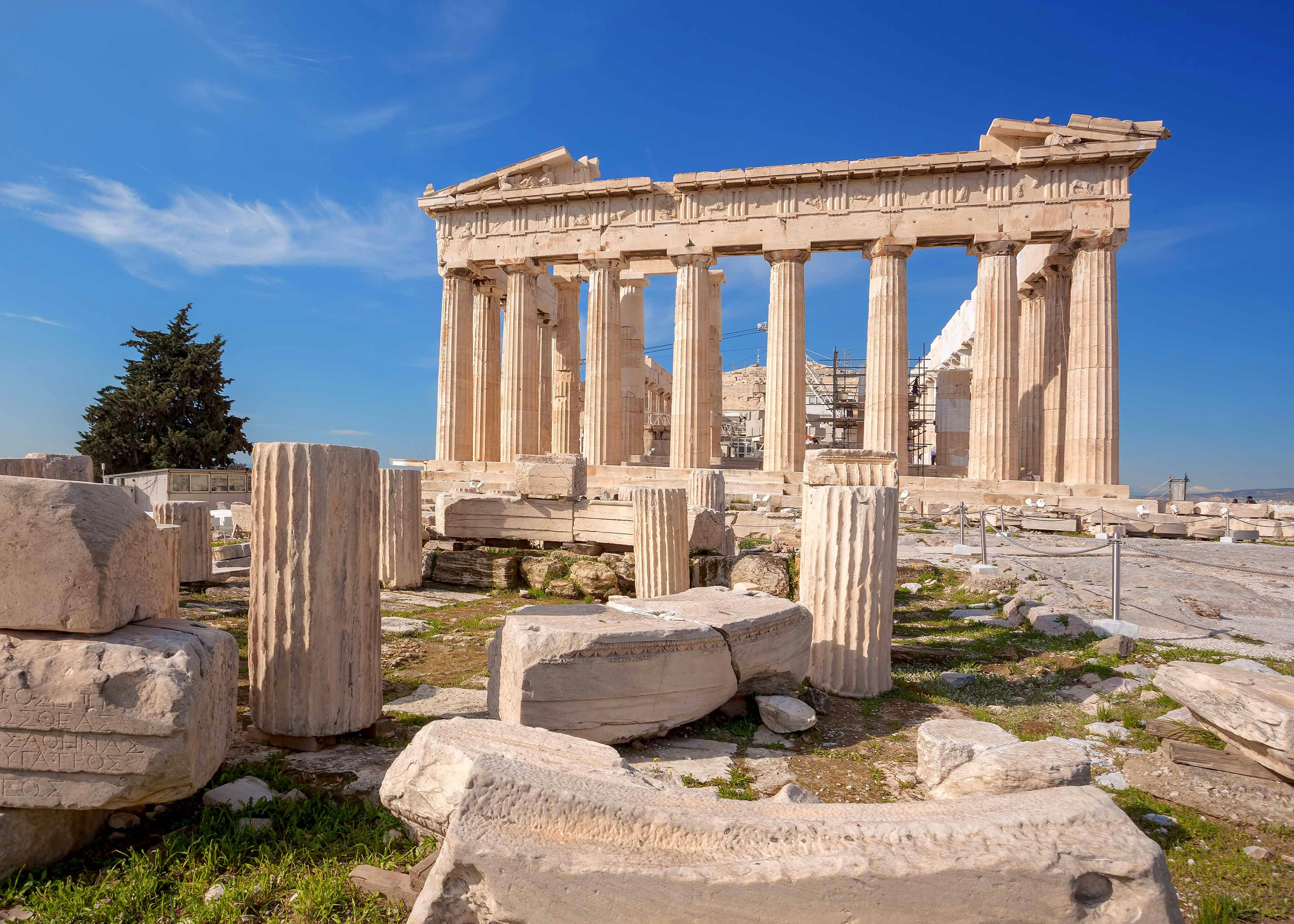 Parthenon ruins with columns and ancient stone fragments in Athens, Greece.