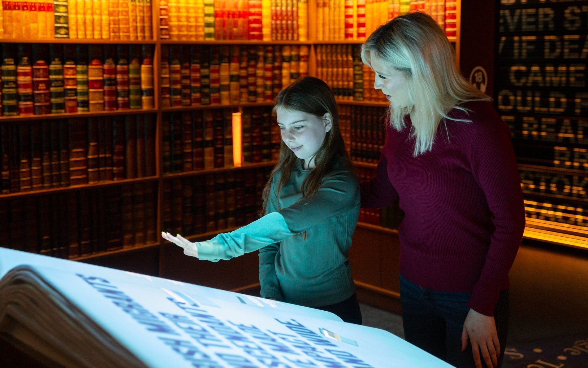 Visitors interacting with a digital display at an epic museum exhibit.