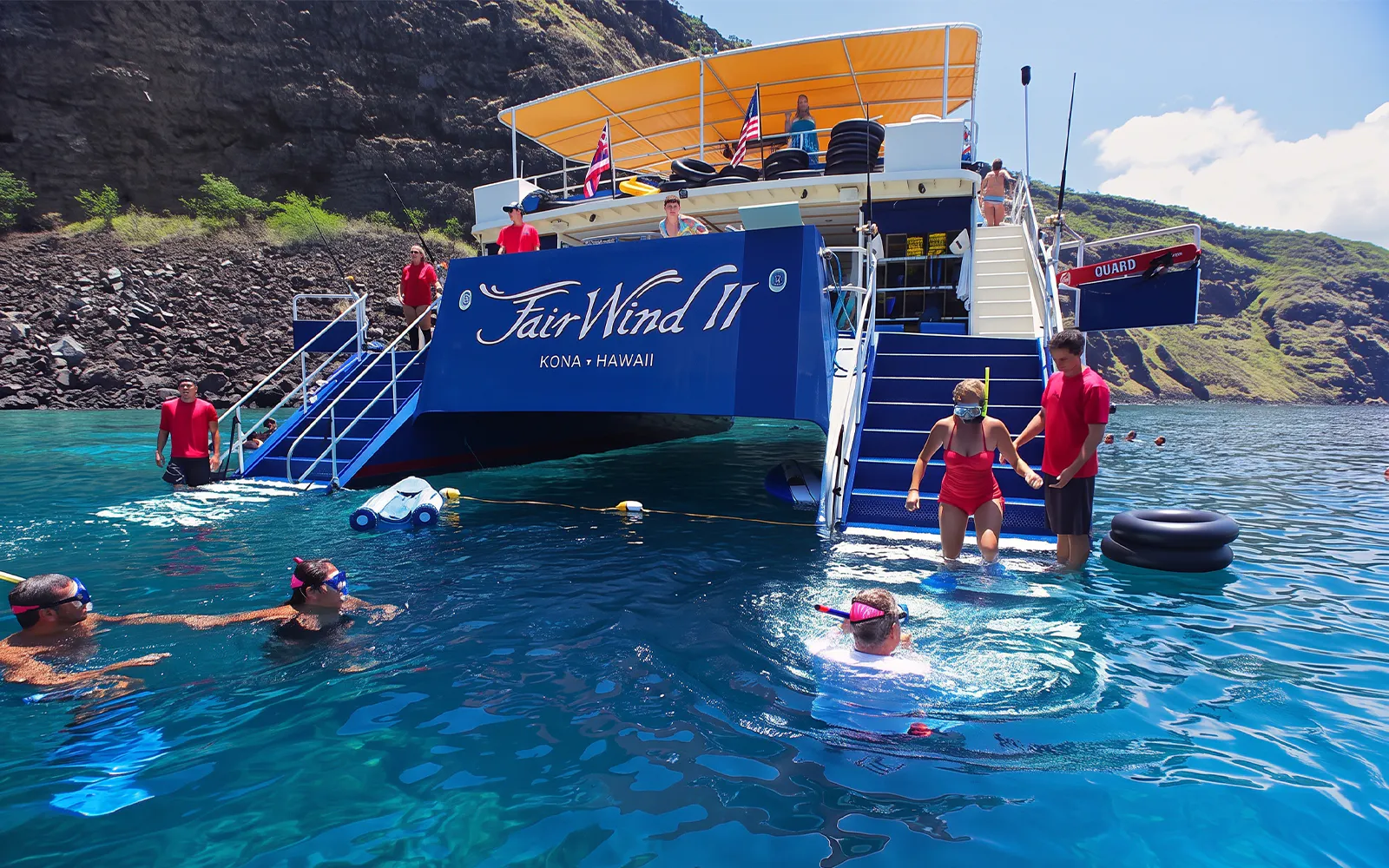 Snorkelers entering water from boat at Kealakekua Bay, Hawaii.