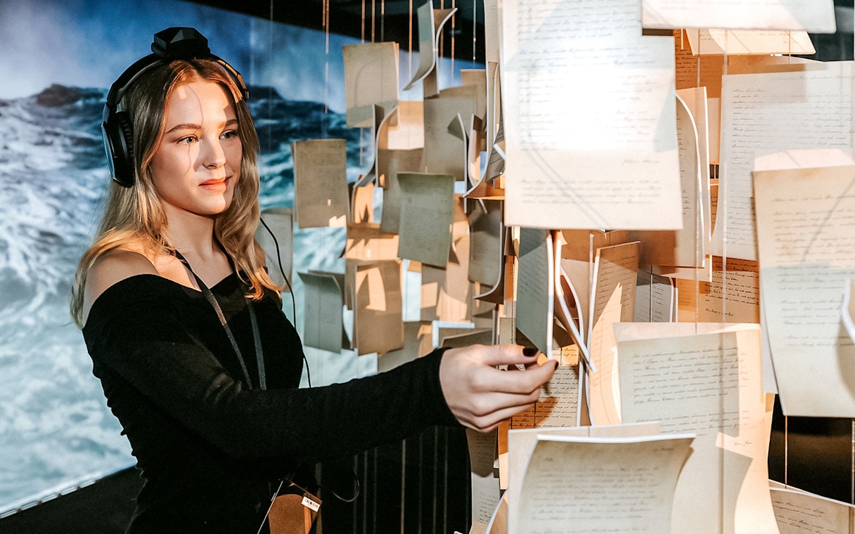 Visitor exploring interactive exhibit at Vienna's Johann Strauss Museum.