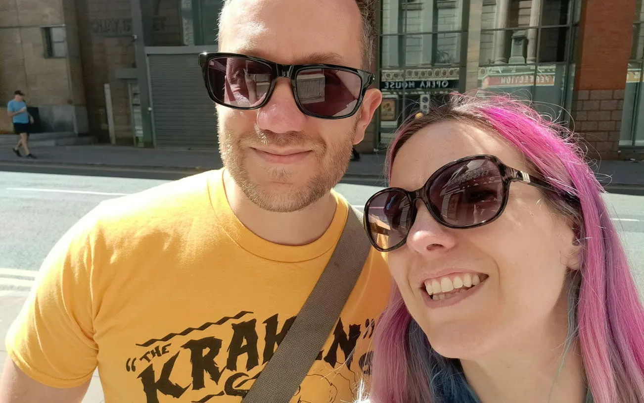 Couple enjoying a sunny day on a self-guided city exploration in Manchester.