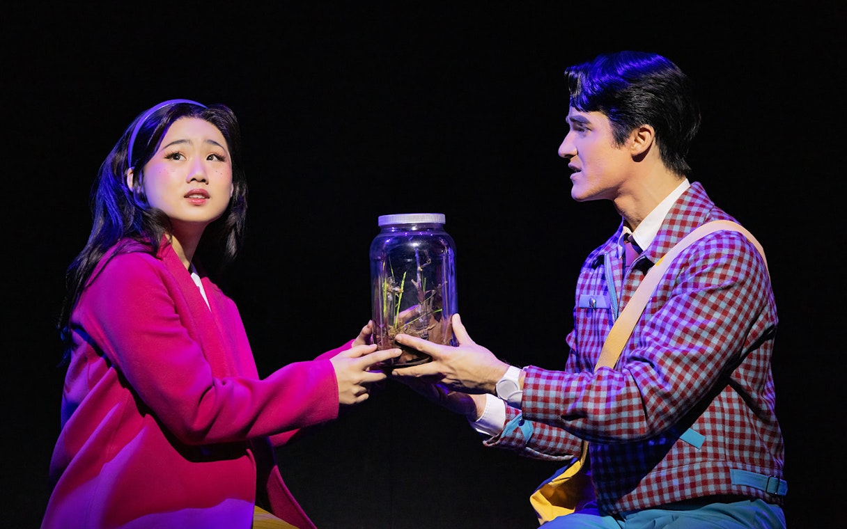 Actors holding a jar during Maybe Happy Ending Broadway show performance.