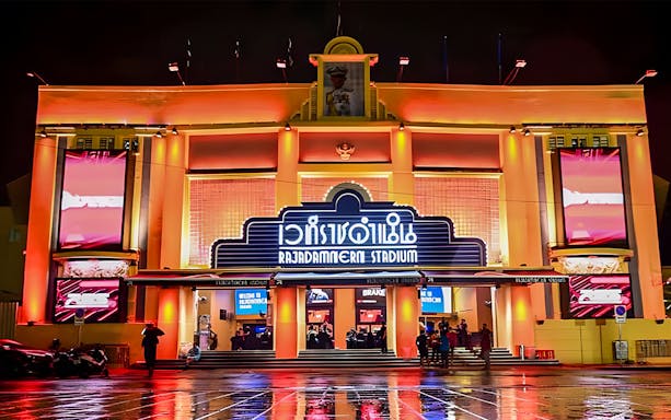 Rajadamnern Boxing Stadium exterior illuminated at night, Bangkok, Thailand.