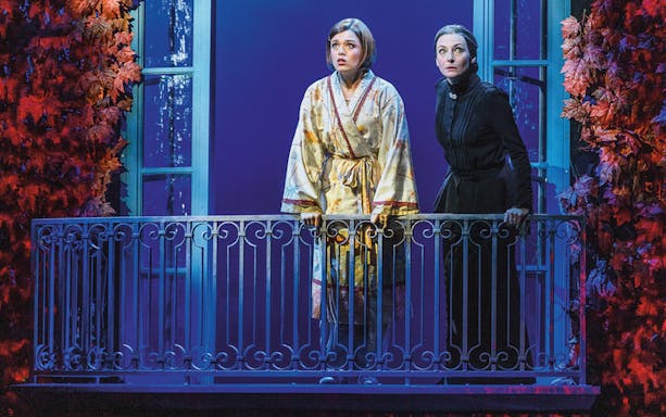 Two actors on a balcony in a scene from Rebecca the musical.