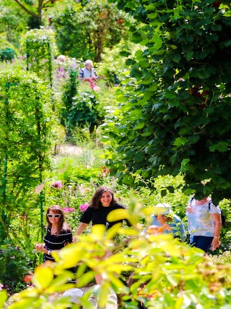 Visitors exploring lush gardens at Claude Monet’s home in Giverny.