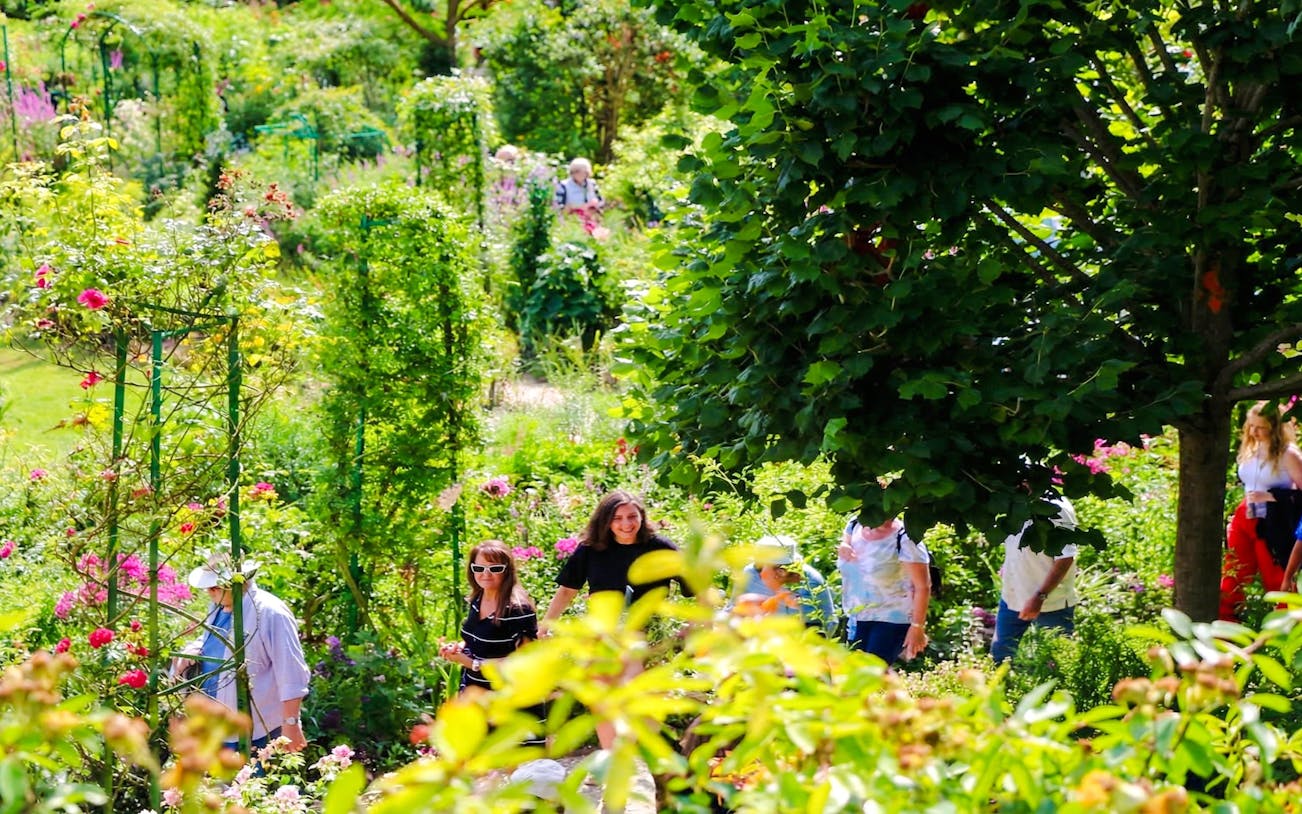 Visitors exploring lush gardens at Claude Monet’s home in Giverny.