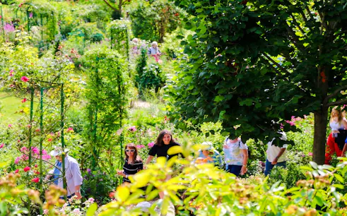 Visitors exploring lush gardens at Claude Monet’s home in Giverny.