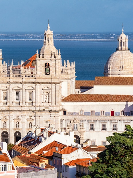 Lisbon's São Vicente de Fora Monastery with Tagus River in the background.