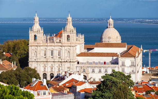 Lisbon's São Vicente de Fora Monastery with Tagus River in the background.