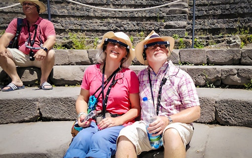Visitors enjoying augmented reality tour at Pompeii ruins.