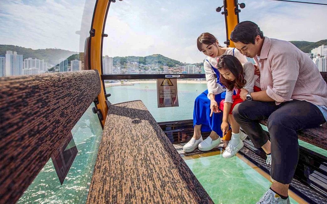 Family enjoying view from Songdo Marine Cable Car in Busan.