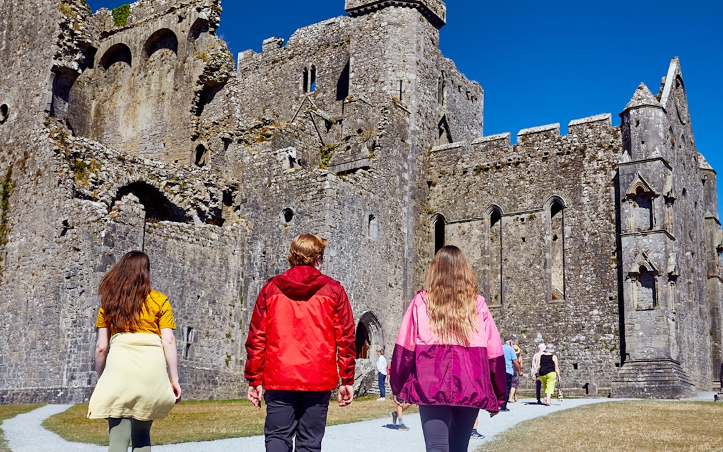 Tourists walking towards Blarney Castle in Ireland.