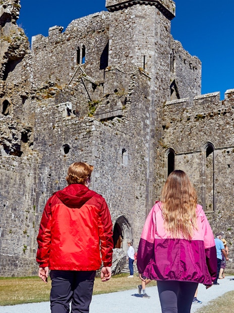Tourists walking towards Blarney Castle in Ireland.