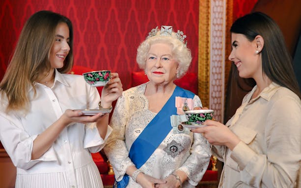 Wax figure of a royal figure with visitors at Madame Tussauds, Budapest.