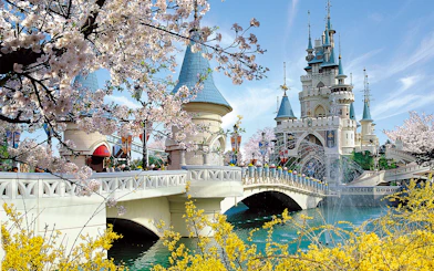 Lotte World castle with cherry blossoms and bridge in Seoul, South Korea.