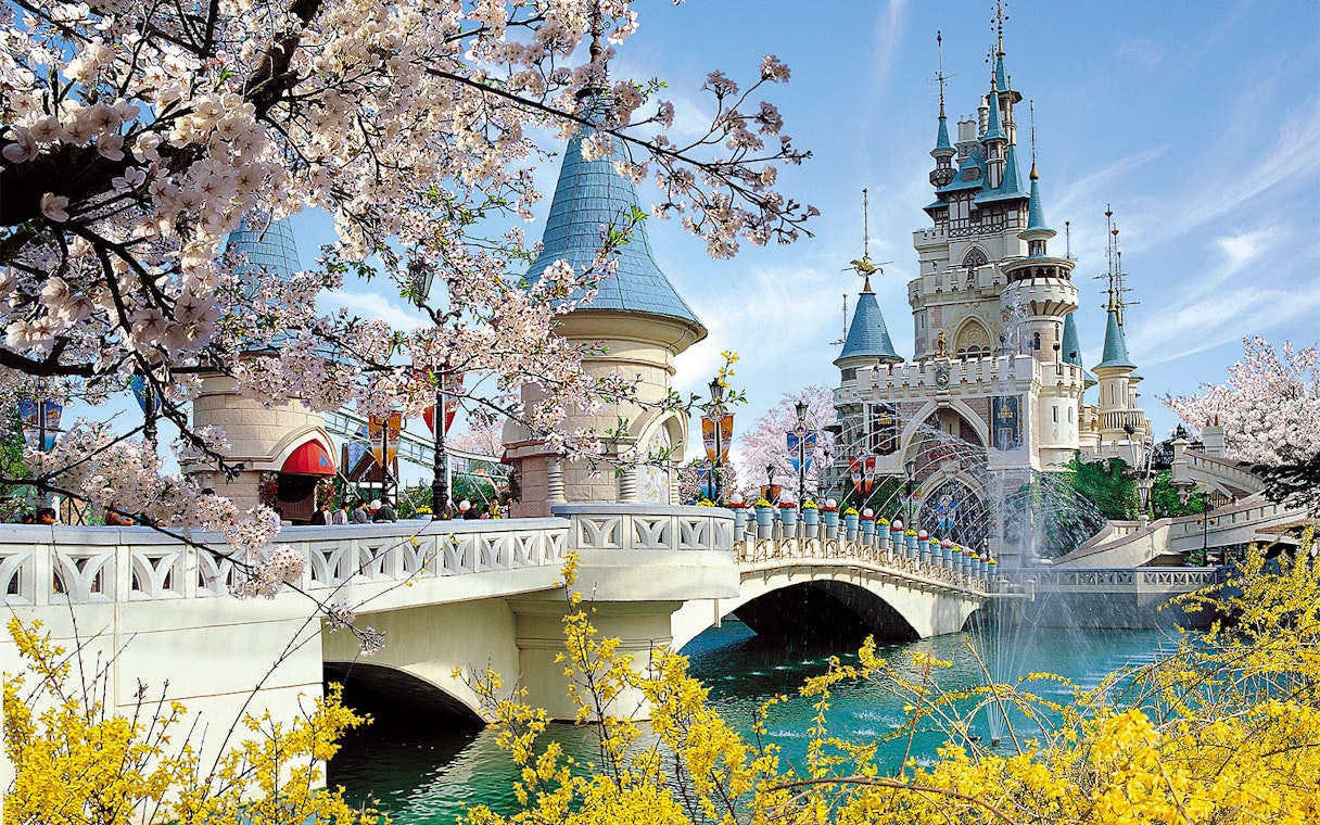 Lotte World castle with cherry blossoms and bridge in Seoul, South Korea.