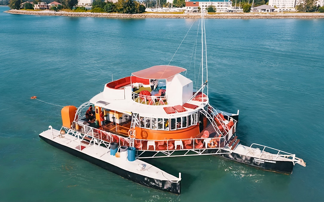 Colorful boat on water for Dragon Sunset Cruise tour.
