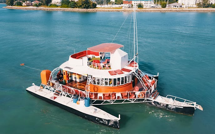 Colorful boat on water for Dragon Sunset Cruise tour.